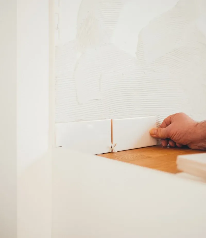 person holding white tile
